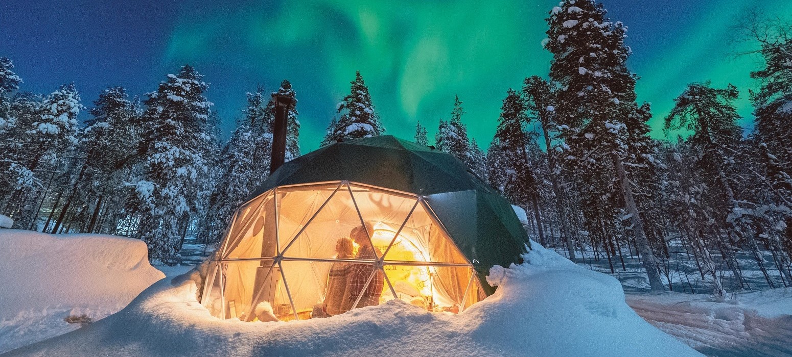 Vista panor&aacute;mica de auroras boreales sobre el paisaje invernal